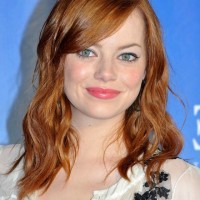 Emma Stone Shoulder Length Red Wavy Hairstyle with Side Swept Bangs